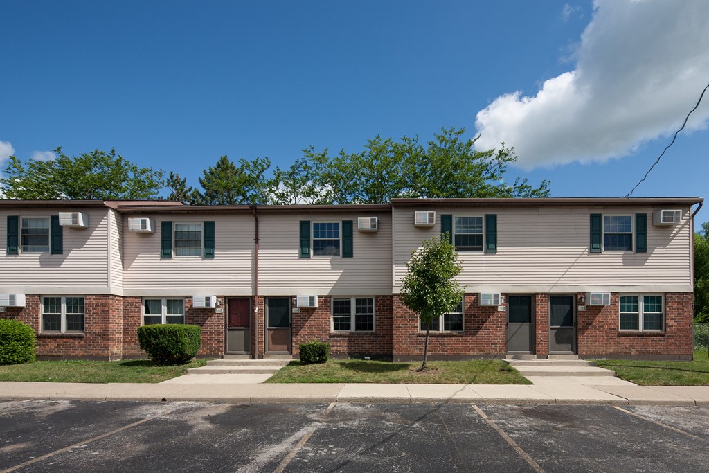 an apartment building with a blue sky in the background