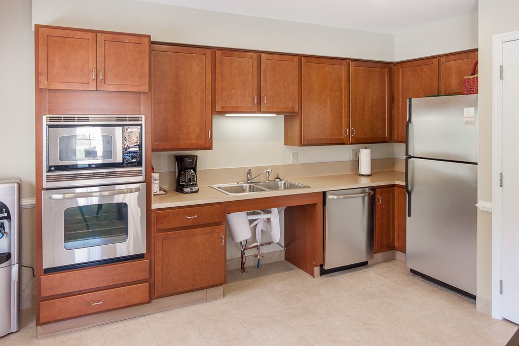 a kitchen with stainless steel appliances and wooden cabinets