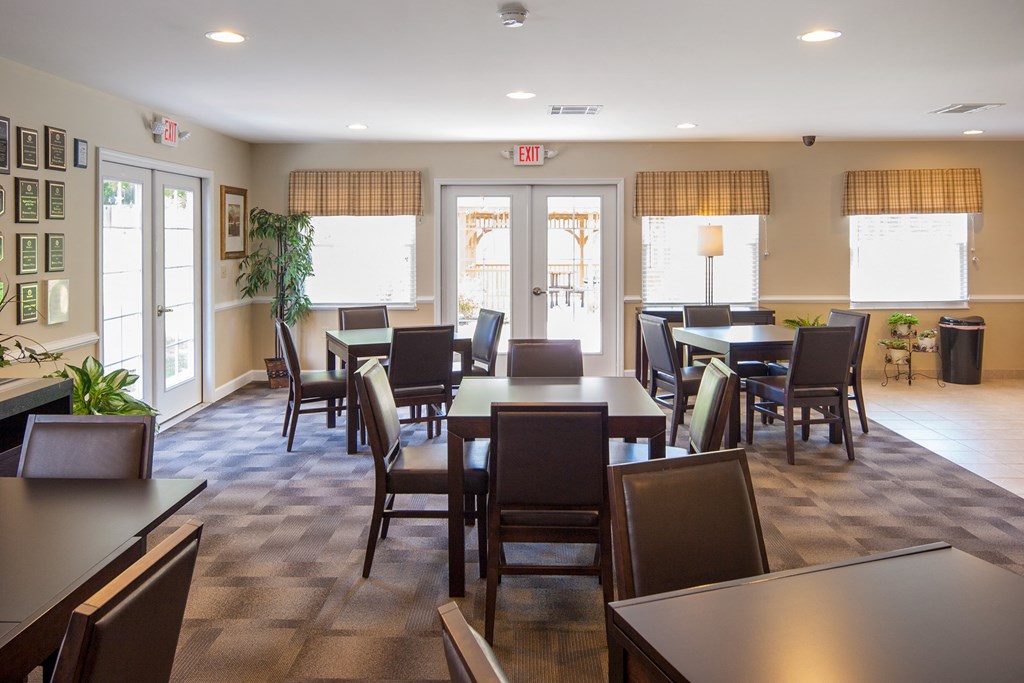 a dining room with tables and chairs in a residence hall