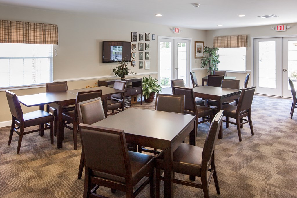 a dining room with tables and chairs and a tv