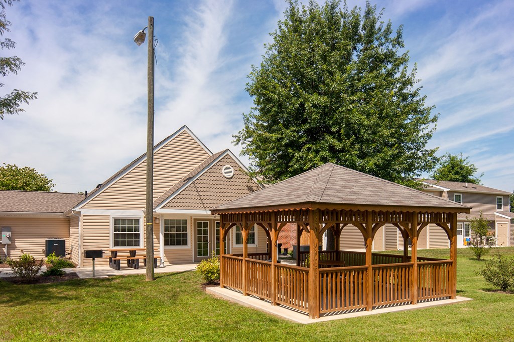 a gazebo with a house in the background
