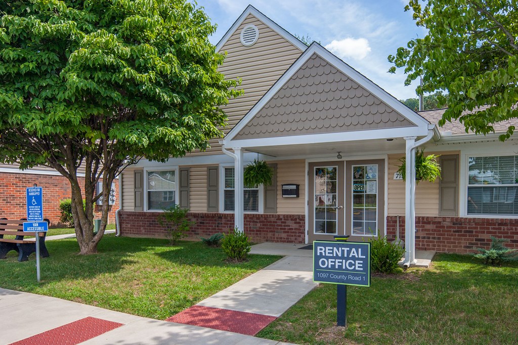 a rental office sign in front of a house