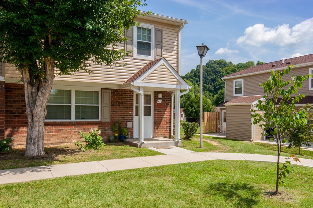 a house with a sidewalk in front of it