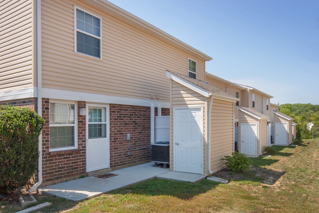 a side view of a house with a white garage door