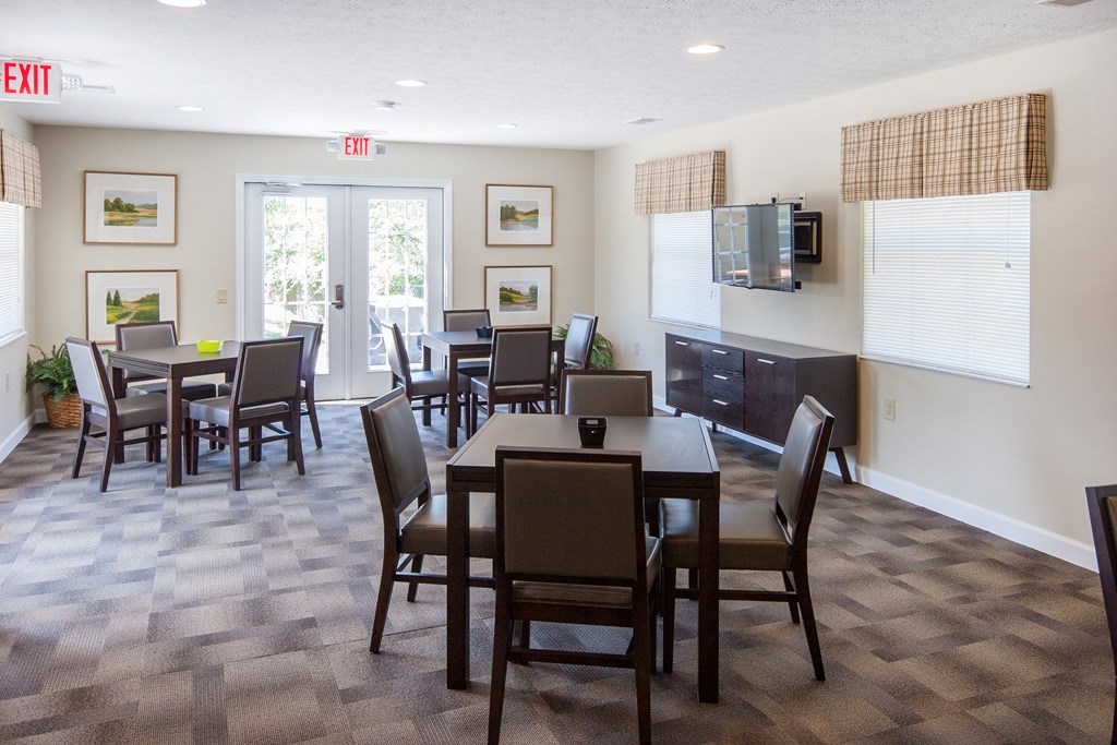 a dining room with a table and chairs and a television