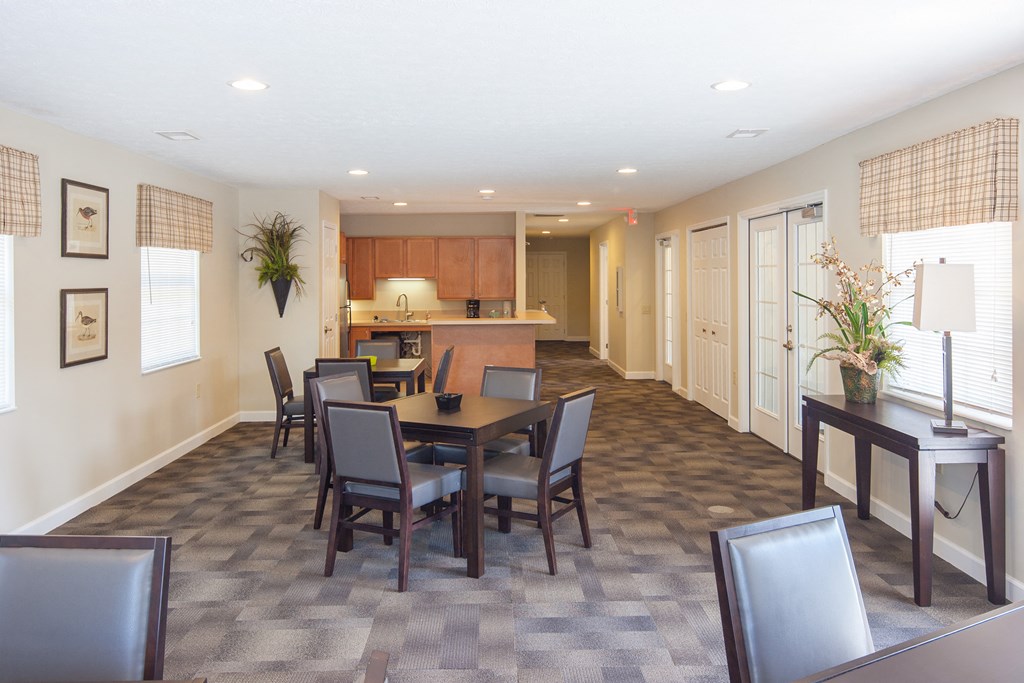 a dining room with a table and chairs and a kitchen