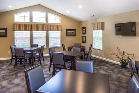 a dining room with tables and chairs and a large window
