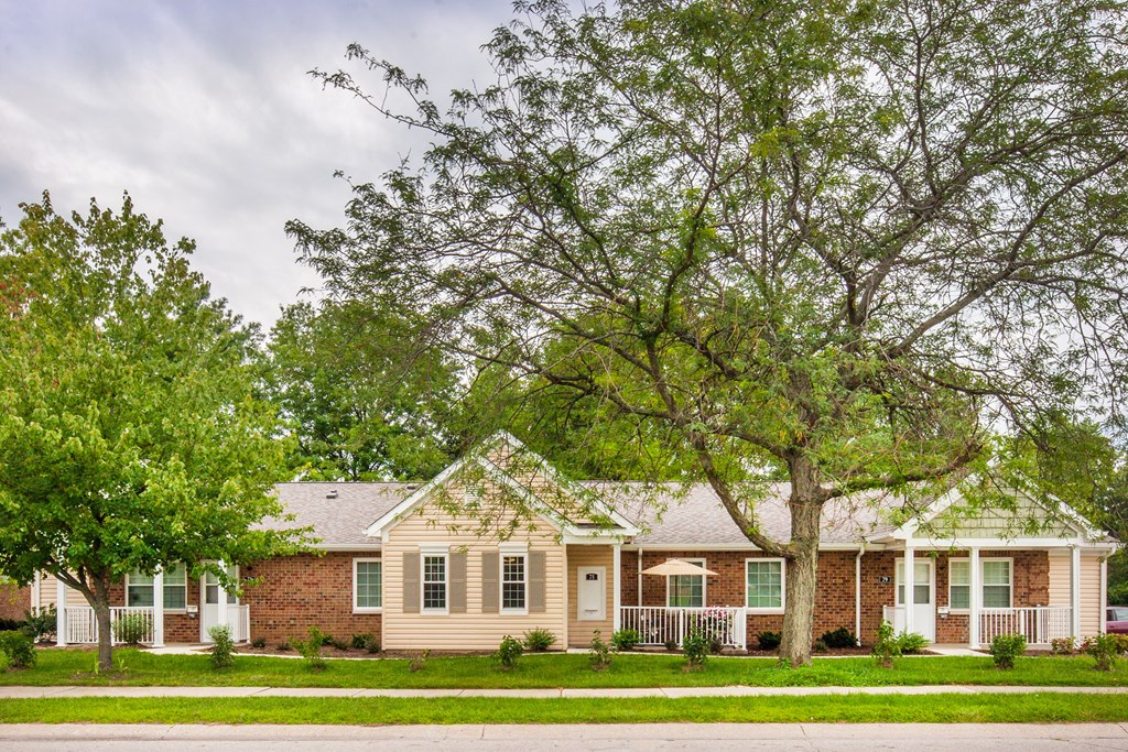 a house with a large tree in front of it