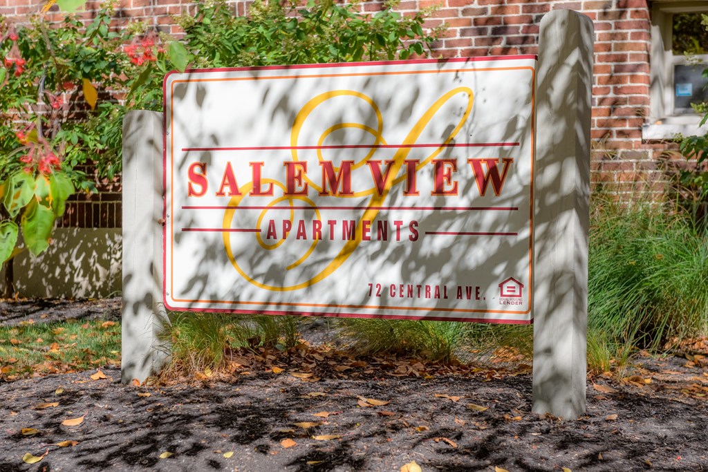 a sign for the salvation army apartments in front of a brick building