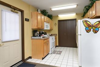 a kitchen with a white refrigerator and a butterfly door