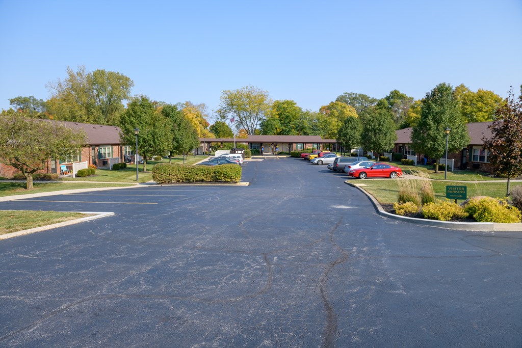a parking lot with cars in front of a building