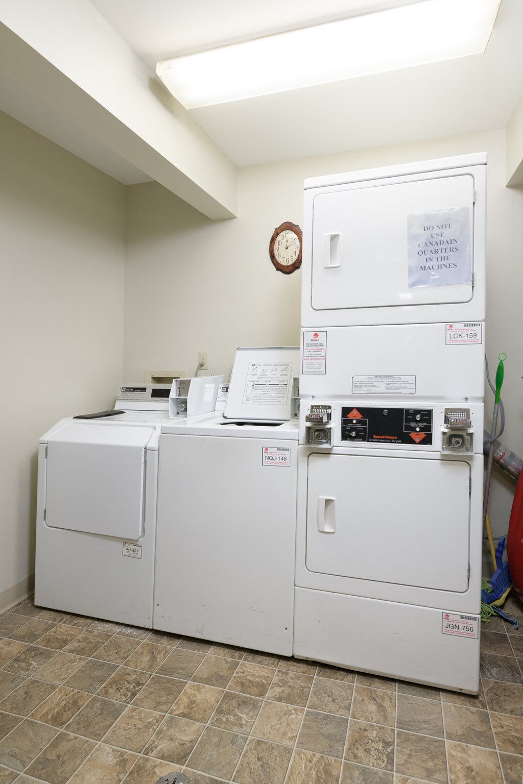 a laundry room with two washes and two washing machines