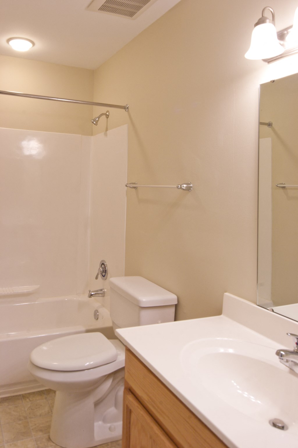 a bathroom with a toilet and a sink and a shower