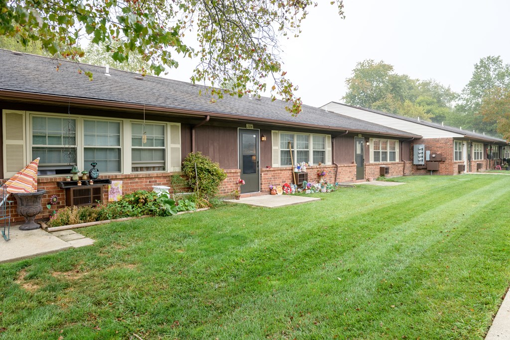the front of a house with a lawn and a porch