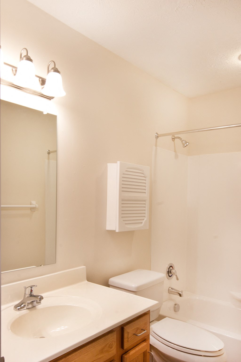 a bathroom with a sink toilet and shower and a mirror