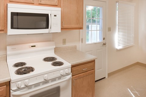 a kitchen with a stove microwave and cabinets