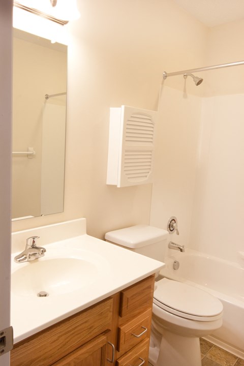 a small bathroom with a sink toilet and shower