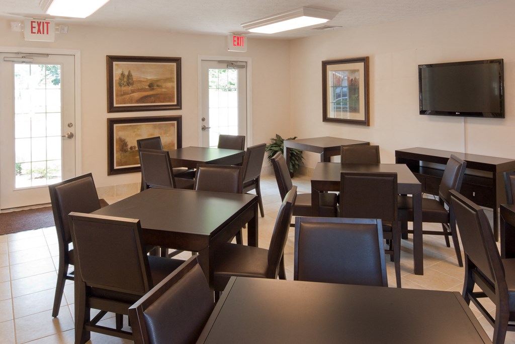 a dining room with tables and chairs and a television