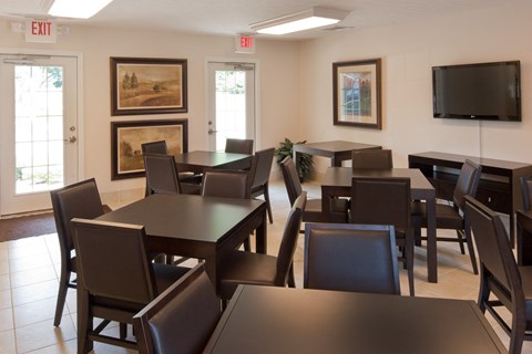 a dining room with tables and chairs and a television