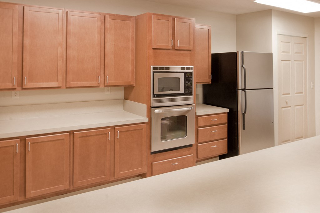 a kitchen with wooden cabinets and stainless steel appliances