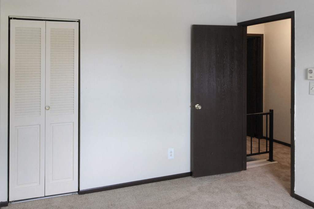 the door to the closet is open to the hallway and the hallway door is closed