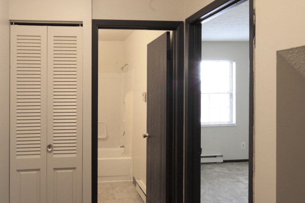 the view of the bathroom from the hallway with the door open