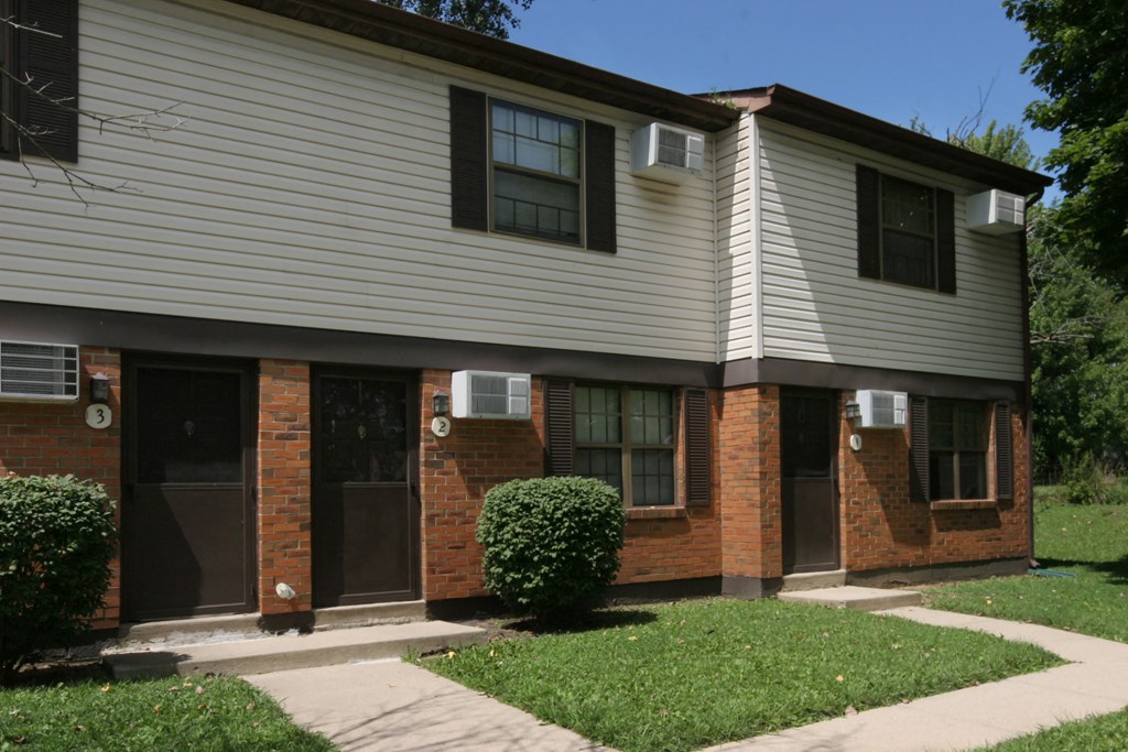 a brick and with a sidewalk and grass