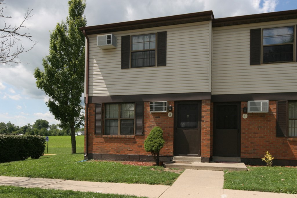 the front of a brick and with a black door