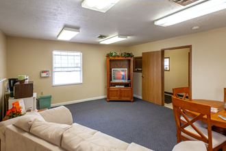 an empty living room with a couch and a tv