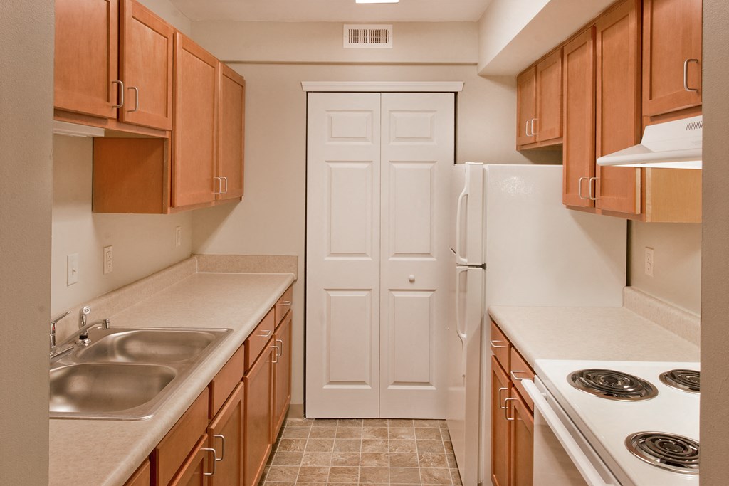 a kitchen with wooden cabinets and a white refrigerator