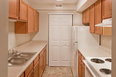 a kitchen with wooden cabinets and a white refrigerator