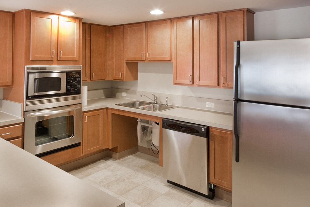 a kitchen with stainless steel appliances and wooden cabinets