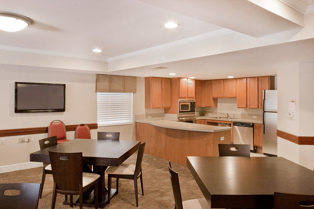 a dining room and kitchen with a table and chairs