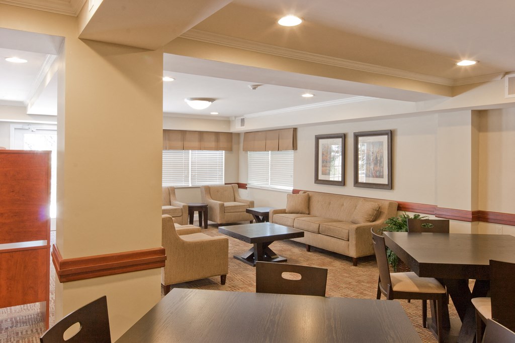 a living room with couches and chairs and a table