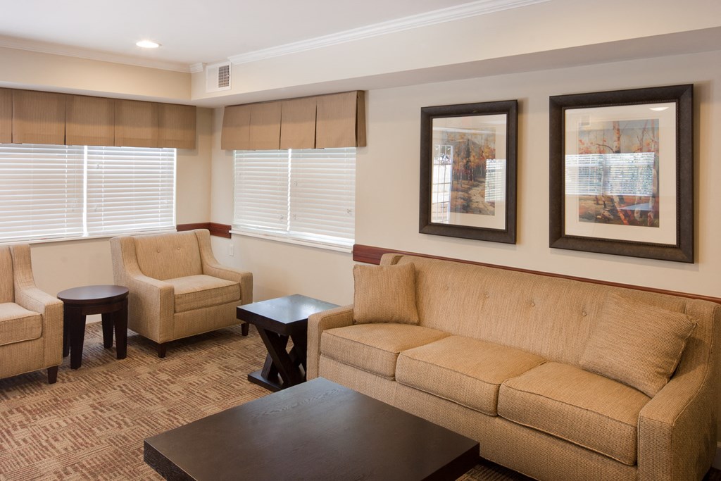 a living room with a couch and chairs and a coffee table