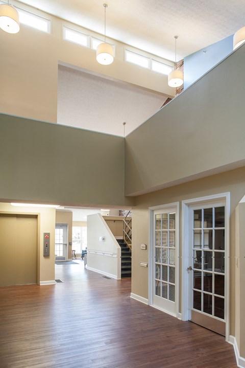 a view of a living room with a staircase and a glass door