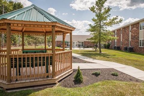 a gazebo with a sidewalk in front of a building