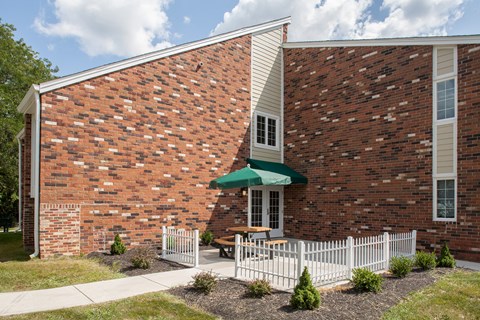 a brick building with a table and umbrella outside of it