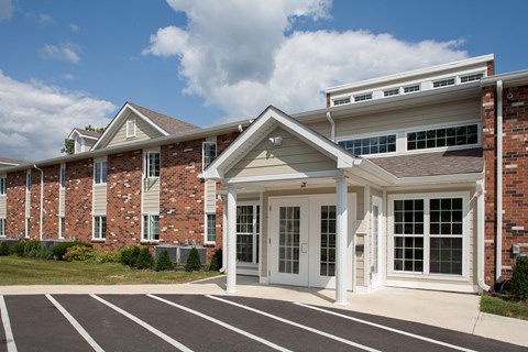 a large brick building with white pillars and a front door