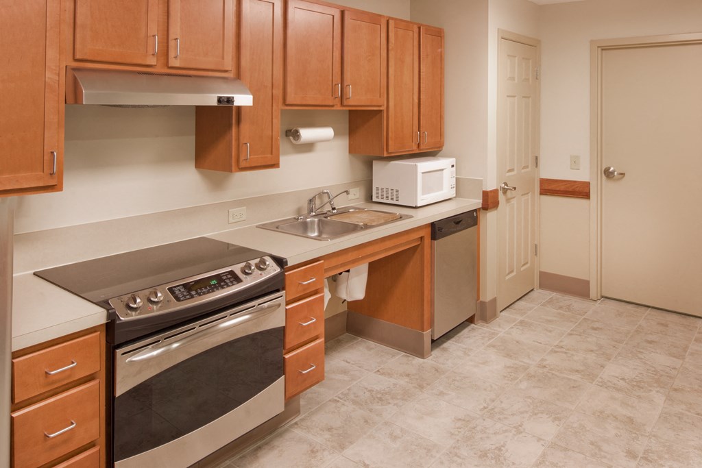 a kitchen with stainless steel appliances and wooden cabinets