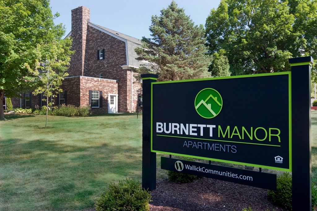 a sign for bunker manor apartments in front of a building