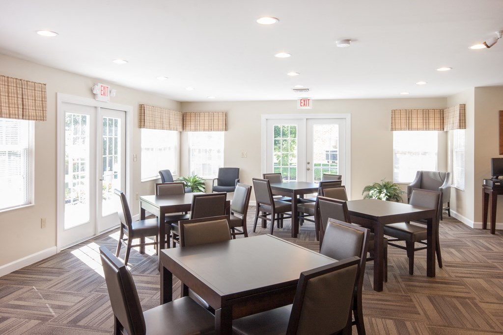 a dining room with tables and chairs in a residence hall