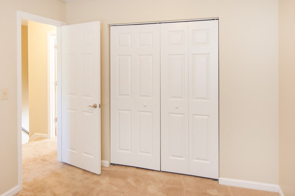 an empty room with two closets and a closet door