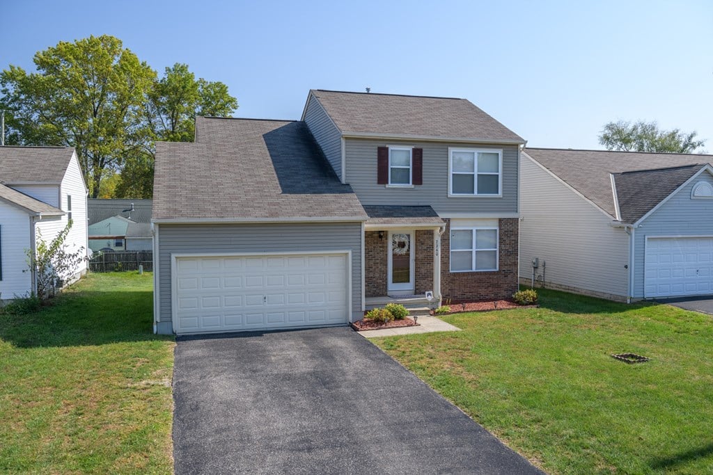 a house with a driveway and a garage door
