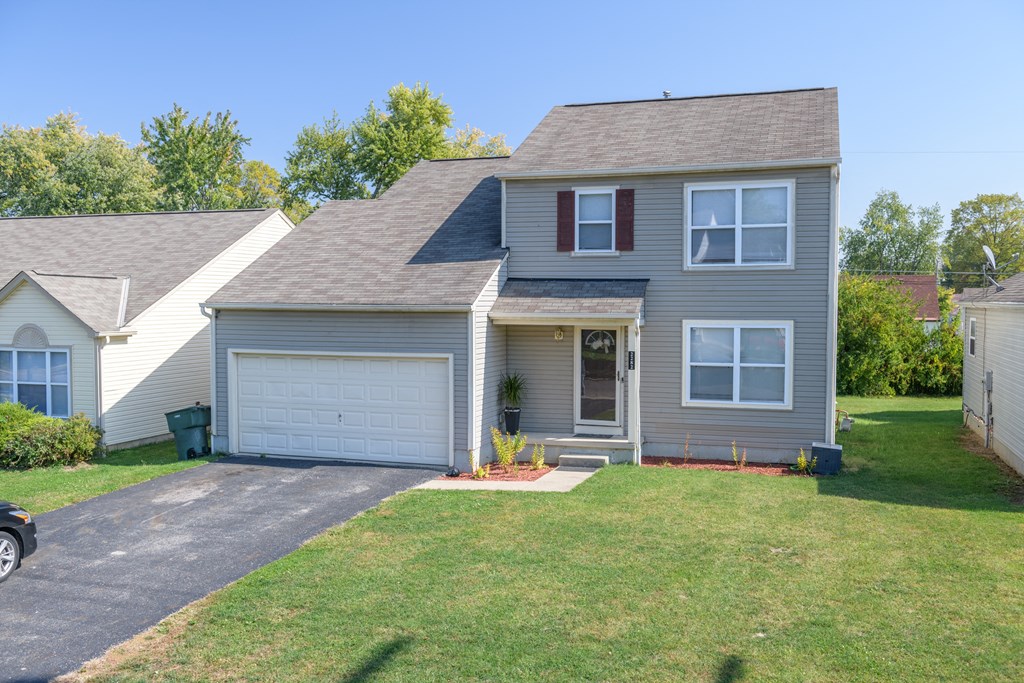 a house with a garage and a lawn
