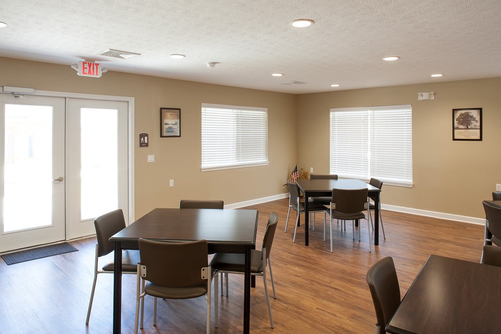 a dining room with tables and chairs and a door