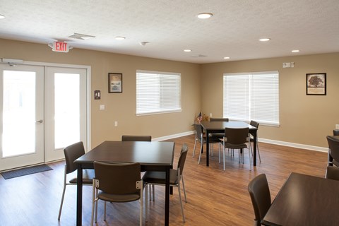 a dining room with tables and chairs and a door
