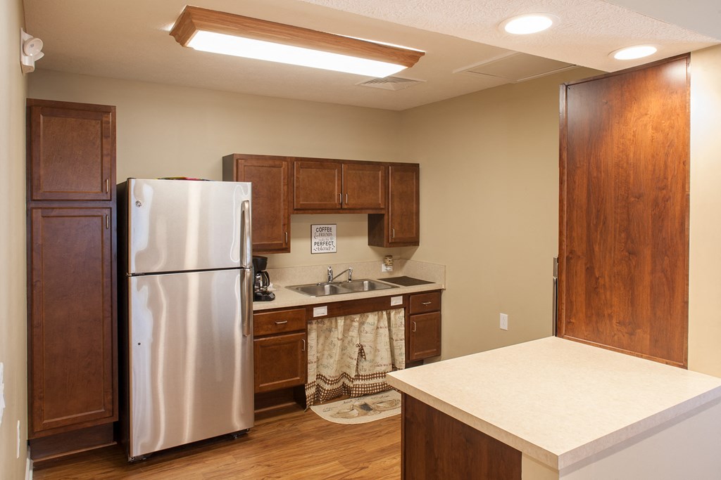 a kitchen with a stainless steel refrigerator and a sink