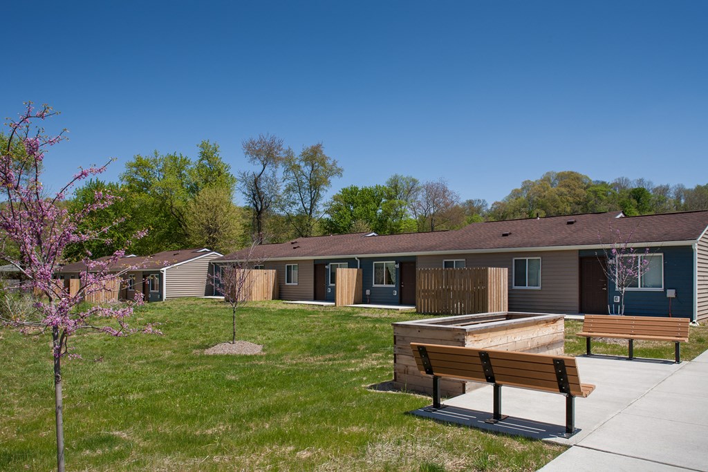 a park with benches in front of a building