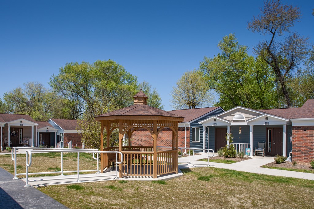 a gazebo in front of a group of houses